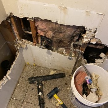 Wall opened up to access and repair a hidden pipe leak behind drywall